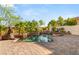 Beautiful pool with a rock waterfall feature and lush landscaping at 10301 Orkiney Dr, Las Vegas, NV 89144