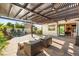 Inviting pool area with shaded seating, lush landscaping, and a tranquil atmosphere for relaxation and enjoyment at 10301 Orkiney Dr, Las Vegas, NV 89144