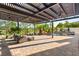 Beautiful pool area with comfortable seating under a shaded pergola, perfect for relaxation and outdoor entertainment at 10301 Orkiney Dr, Las Vegas, NV 89144