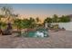 Beautiful pool with a rock waterfall feature and lush landscaping at 10301 Orkiney Dr, Las Vegas, NV 89144