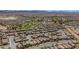 Expansive aerial view of a Primary-planned community with lush golf course, stunning mountain backdrop, and picturesque neighborhood at 1104 Aspen Cliff Dr, Henderson, NV 89011