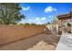 Backyard featuring a brick wall and a gate at 1104 Aspen Cliff Dr, Henderson, NV 89011