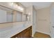 Bathroom with a large mirror and a vanity with dark wood cabinets at 1104 Aspen Cliff Dr, Henderson, NV 89011