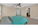 Bright bedroom featuring a ceiling fan, neutral walls, and an attached bathroom at 1104 Aspen Cliff Dr, Henderson, NV 89011