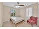 Neutral bedroom with ceiling fan, one bed, and a decorative chair at 1104 Aspen Cliff Dr, Henderson, NV 89011