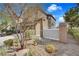 Side view of a two-story home with a low-maintenance rock garden and a privacy fence at 1104 Aspen Cliff Dr, Henderson, NV 89011