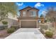 Inviting two-story home features a neatly kept front yard and a spacious two-car garage at 1104 Aspen Cliff Dr, Henderson, NV 89011
