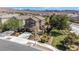 Two-story home with desert landscaping, a balcony, and an attached two-car garage at 1104 Aspen Cliff Dr, Henderson, NV 89011