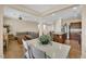 Open concept kitchen with an island, granite counters, stainless appliances, and an adjacent dining area and living room at 1104 Aspen Cliff Dr, Henderson, NV 89011