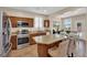 Kitchen featuring stainless steel appliances, granite countertops, breakfast bar, and a view of the dining area at 1104 Aspen Cliff Dr, Henderson, NV 89011