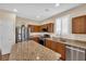 Modern kitchen with stainless steel appliances, granite countertops, ample cabinetry, and natural light at 1104 Aspen Cliff Dr, Henderson, NV 89011