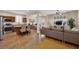 Bright and airy living area with tile floors, an open kitchen, and a large window at 1104 Aspen Cliff Dr, Henderson, NV 89011