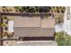 Aerial view of the rooftop and backyard area with patio and desert landscaping at 1104 Aspen Cliff Dr, Henderson, NV 89011