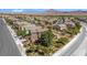 Street view of the neighborhood and the two-story home with desert landscaping at 1104 Aspen Cliff Dr, Henderson, NV 89011