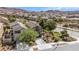 View of the two-story home with desert landscaping, a balcony, and an attached two-car garage at 1104 Aspen Cliff Dr, Henderson, NV 89011