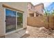 A zero-maintenance backyard featuring a brick wall, decorative rock, a small tree and shrubbery at 11221 Victoria Medici St, Las Vegas, NV 89141