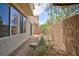 A zero-maintenance backyard featuring a brick wall, decorative rock and shrubbery at 11221 Victoria Medici St, Las Vegas, NV 89141