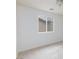 Bedroom with neutral walls and carpet, complemented by natural light streaming through the window at 11221 Victoria Medici St, Las Vegas, NV 89141