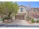 Charming two-story home featuring an attached two-car garage and mature landscaping at 11221 Victoria Medici St, Las Vegas, NV 89141