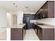 Spacious kitchen with granite countertops, dark cabinetry, and stainless steel appliances at 11221 Victoria Medici St, Las Vegas, NV 89141
