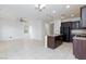 Open living space with tile flooring, recessed lighting, and a kitchen area at 11221 Victoria Medici St, Las Vegas, NV 89141