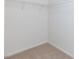 A walk-in closet with shelving and carpeted floors, ready for organizing your wardrobe at 11221 Victoria Medici St, Las Vegas, NV 89141