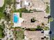 Aerial view of a luxury home featuring a backyard pool, spa, and lush landscaping at 11503 Glowing Sunset Ln, Las Vegas, NV 89135