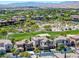 Scenic aerial view of a luxury home nestled among lush landscaping and a golf course at 11503 Glowing Sunset Ln, Las Vegas, NV 89135