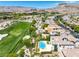Scenic aerial view of a luxury home with a backyard pool near a golf course at 11503 Glowing Sunset Ln, Las Vegas, NV 89135