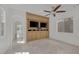 Spacious bedroom with ceiling fan, built-in media center, and light tile flooring throughout at 11503 Glowing Sunset Ln, Las Vegas, NV 89135