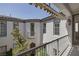 Exterior view of a private courtyard with a small wrought-iron balcony and garden at 11503 Glowing Sunset Ln, Las Vegas, NV 89135
