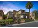 Stunning home exterior features a gated courtyard and meticulously maintained landscaping at 11503 Glowing Sunset Ln, Las Vegas, NV 89135
