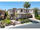 Imposing residence featuring lush landscaping, stone accents, a tile roof, and a grand entryway at 11503 Glowing Sunset Ln, Las Vegas, NV 89135