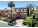 Elegant home with a tile roof, three-car garage, mature palm trees, and lush landscaping at 11503 Glowing Sunset Ln, Las Vegas, NV 89135