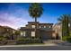 Beautiful two-story home with stone accents, a tile roof, and lush landscaping at 11503 Glowing Sunset Ln, Las Vegas, NV 89135