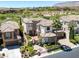 Luxury two-story home featuring lush landscaping, a tiled roof, and a gated courtyard at 11503 Glowing Sunset Ln, Las Vegas, NV 89135