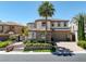 Stately two-story home with stone accents, a tile roof, mature landscaping, and a large palm tree at 11503 Glowing Sunset Ln, Las Vegas, NV 89135