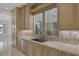 Kitchen countertop with a stainless steel sink, mosaic tile backsplash, and custom cabinets at 11503 Glowing Sunset Ln, Las Vegas, NV 89135