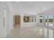 Living room with built-in shelving, tile floors, and views of the backyard at 11503 Glowing Sunset Ln, Las Vegas, NV 89135