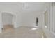 Bright living room featuring tile floors, white walls, and an arched doorway at 11503 Glowing Sunset Ln, Las Vegas, NV 89135
