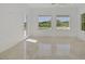 Spacious living room featuring tile floors, white walls, and views of the outdoor pool area at 11503 Glowing Sunset Ln, Las Vegas, NV 89135