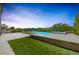 Backyard features a pool, spa, and grassy area, perfect for outdoor enjoyment and relaxation at 11503 Glowing Sunset Ln, Las Vegas, NV 89135