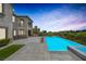 Stunning backyard with pool, spa, outdoor kitchen, and immaculate landscaping, offering ultimate relaxation at 11503 Glowing Sunset Ln, Las Vegas, NV 89135