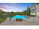 Charming pool area with built-in fire pit, surrounded by mature landscaping and picturesque desert views at 11503 Glowing Sunset Ln, Las Vegas, NV 89135