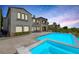Inviting backyard pool and spa area with an outdoor kitchen and desert landscaping, ideal for entertaining at 11503 Glowing Sunset Ln, Las Vegas, NV 89135
