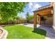 Inviting backyard featuring lush green lawn, brick-paved patio and tasteful landscaping at 11847 Corenzio Ave, Las Vegas, NV 89138