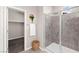 Bathroom featuring tiled shower with glass door, decorative basket, and closet entrance at 11847 Corenzio Ave, Las Vegas, NV 89138