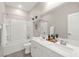 Bright bathroom features double sinks, shower over tub, and ample lighting at 11847 Corenzio Ave, Las Vegas, NV 89138