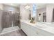 Bathroom showcasing a glass-enclosed shower, double sink vanity, and contemporary design at 11847 Corenzio Ave, Las Vegas, NV 89138