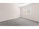 A bright, carpeted bedroom featuring a large window and neutral paint at 11847 Corenzio Ave, Las Vegas, NV 89138